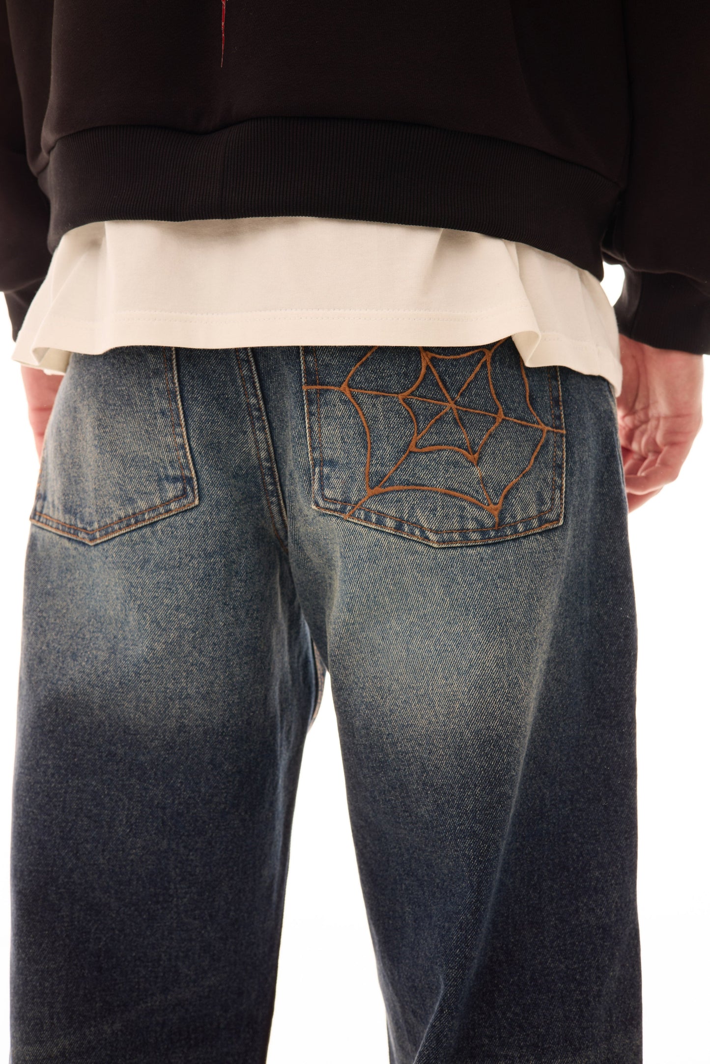 Detaliu buzunar spate al blugilor Classic Denim wide fit, cu stonewash, used wash și mustache fading, plus broderie în formă de pânză de păianjen.
